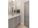 Well-lit bathroom with a grey vanity, quartz countertop, modern mirror, and a grey painted door at 3726 Orion Ln, Mount Pleasant, SC 29466