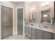 Beautiful bathroom featuring double vanities, gray cabinets, granite countertops, and modern fixtures at 3726 Orion Ln, Mount Pleasant, SC 29466
