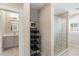 Bright bathroom with grey vanity, glass shower door, and tiled shower; linen shelving with towels nearby at 3726 Orion Ln, Mount Pleasant, SC 29466