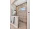 Stunning tiled shower with glass enclosure, window, and stone floor at 3726 Orion Ln, Mount Pleasant, SC 29466