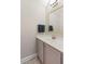 Modern bathroom with neutral walls, a sink with grey cabinetry, a framed mirror, and hanging towels at 3726 Orion Ln, Mount Pleasant, SC 29466