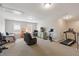 Spacious bonus room featuring a daybed, recliner, treadmill, and stationary bike, offering versatile space at 3726 Orion Ln, Mount Pleasant, SC 29466