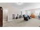 Spacious bonus room featuring neutral carpet, comfortable seating, exercise equipment, and abundant natural light at 3726 Orion Ln, Mount Pleasant, SC 29466