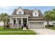 Charming two-story home with a covered front porch, brick accents, and a well-manicured lawn and two-car garage at 3726 Orion Ln, Mount Pleasant, SC 29466