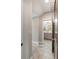 Hallway featuring neutral tiling and leading to a bathroom with a grey vanity and a framed mirror at 3726 Orion Ln, Mount Pleasant, SC 29466