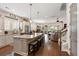 Open-concept kitchen featuring a large center island with seating, stainless steel appliances, and hardwood floors at 3726 Orion Ln, Mount Pleasant, SC 29466
