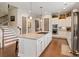 Spacious kitchen features a large island, double ovens, white cabinets, and easy access to the staircase at 3726 Orion Ln, Mount Pleasant, SC 29466