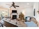 Cozy living room with a fireplace, comfortable seating, and a ceiling fan, ideal for relaxation at 3726 Orion Ln, Mount Pleasant, SC 29466