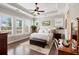 Serene main bedroom with tray ceilings, natural light, hardwood floors and views of the backyard and landscaping at 3726 Orion Ln, Mount Pleasant, SC 29466