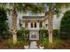 Charming backyard featuring a stone walkway, lush greenery, palm trees, and an inviting fire pit at 3741 Juneberry Ct, Mount Pleasant, SC 29466