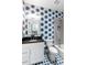 Bathroom with blue palm-leaf wallpaper, vanity, mirror, and shower/tub combination at 3741 Juneberry Ct, Mount Pleasant, SC 29466