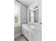 Bathroom vanity with white cabinets, and a view through plantation shutters at 3741 Juneberry Ct, Mount Pleasant, SC 29466