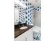 Bathroom with blue palm-leaf wallpaper, a dark countertop, vanity and a shower/tub at 3741 Juneberry Ct, Mount Pleasant, SC 29466