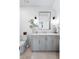 Charming bathroom with a light gray vanity, stylish fixtures, a framed mirror, and neutral decor at 3741 Juneberry Ct, Mount Pleasant, SC 29466