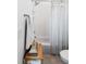 Clean bathroom featuring white subway tile, a bathtub with a shower, and a handy storage shelf at 3741 Juneberry Ct, Mount Pleasant, SC 29466