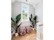 Bright hallway landing features natural light, hardwood floors, plants, and matching ottomans at 3741 Juneberry Ct, Mount Pleasant, SC 29466