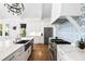 Bright kitchen features a large island, marble countertops, designer lighting, stainless appliances, and white cabinets at 3741 Juneberry Ct, Mount Pleasant, SC 29466