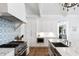Bright kitchen features a large island, marble countertops, designer lighting, stainless appliances, and white cabinets at 3741 Juneberry Ct, Mount Pleasant, SC 29466
