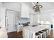 Bright kitchen features a large island, marble countertops, designer lighting, stainless appliances, and white cabinets at 3741 Juneberry Ct, Mount Pleasant, SC 29466