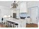 Bright kitchen features a large island, marble countertops, designer lighting, stainless appliances, and white cabinets at 3741 Juneberry Ct, Mount Pleasant, SC 29466