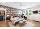 A view of the bedroom showcases a ceiling fan, walk-in closet, floral wallpaper, and a bright desk area at 3741 Juneberry Ct, Mount Pleasant, SC 29466