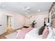 Bright bedroom with an accent wall and soft lighting, along with a cozy seating area and wood floors at 3741 Juneberry Ct, Mount Pleasant, SC 29466
