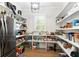 Walk-in pantry with open shelving and stainless steel refrigerator provides ample space for storage at 3741 Juneberry Ct, Mount Pleasant, SC 29466