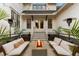 Inviting patio with a modern fire pit, comfortable seating, string lights, and tropical landscaping at 3741 Juneberry Ct, Mount Pleasant, SC 29466