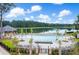 Community pool area with lounge chairs and tables next to a serene lake, perfect for relaxation at 3741 Juneberry Ct, Mount Pleasant, SC 29466