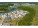 Scenic aerial view of neighborhood with lakefront houses surrounded by lush greenery and mature trees at 393 Tupelo Lake Dr, Summerville, SC 29486
