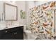 Well-lit bathroom with a modern vanity, large mirror, stylish shower curtain, and neutral wall color at 393 Tupelo Lake Dr, Summerville, SC 29486