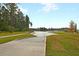 Community boat ramp offers easy access to the waterway, set among lush landscaping and towering trees at 393 Tupelo Lake Dr, Summerville, SC 29486