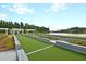 Bocce ball court with pergola and seating, overlooking a tranquil lake at 393 Tupelo Lake Dr, Summerville, SC 29486
