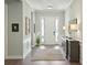 Inviting entryway featuring hardwood floors, a console table with lamps, and a front door with sidelights at 393 Tupelo Lake Dr, Summerville, SC 29486