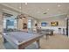 Well-equipped game room with a pool table, high-top tables, and wall-mounted televisions at 393 Tupelo Lake Dr, Summerville, SC 29486