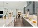 Bright and open kitchen with stainless steel appliances, light countertops, and gray cabinets at 393 Tupelo Lake Dr, Summerville, SC 29486