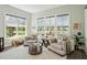 Cozy sitting room with bright windows overlooking a lake with comfortable seating, and neutral decor at 393 Tupelo Lake Dr, Summerville, SC 29486
