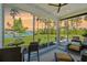 Relaxing sunroom overlooking a lake with sunset views, perfect for outdoor dining at 393 Tupelo Lake Dr, Summerville, SC 29486