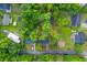 Aerial view of the property, outlined in red, highlighting its placement within a lush, green and tree-filled neighborhood at 411 Berkeley Dr, Moncks Corner, SC 29461