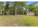 Lush backyard features mature trees and storage shed at 411 Berkeley Dr, Moncks Corner, SC 29461