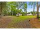 Large backyard featuring trees and a storage shed at 411 Berkeley Dr, Moncks Corner, SC 29461