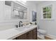 Bright bathroom featuring a modern vanity, framed mirror, and a window for natural light at 411 Berkeley Dr, Moncks Corner, SC 29461