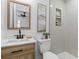 Modern bathroom featuring a wood vanity, updated fixtures, and a tiled shower with niche at 411 Berkeley Dr, Moncks Corner, SC 29461