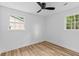 Bright bedroom features two windows and hardwood floors at 411 Berkeley Dr, Moncks Corner, SC 29461