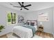 Bright bedroom featuring a ceiling fan, two windows, and a plush rug at 411 Berkeley Dr, Moncks Corner, SC 29461