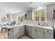 Well-lit kitchen boasts white countertops, stainless steel dishwasher, and easy access to the dining area at 411 Berkeley Dr, Moncks Corner, SC 29461