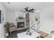 Inviting living room with a fireplace, built-in shelves, and staircase to upper level at 411 Berkeley Dr, Moncks Corner, SC 29461