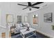 Bright living room with white walls, a ceiling fan, and ample natural light at 411 Berkeley Dr, Moncks Corner, SC 29461