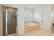 Bathroom with a glass-enclosed shower and luxurious soaking tub with tile surround, offering relaxation at 416 Barbadian Way, Mount Pleasant, SC 29464