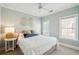 Bedroom with neutral walls and carpet, two windows, and a comfortable bed, creating a cozy retreat at 416 Barbadian Way, Mount Pleasant, SC 29464